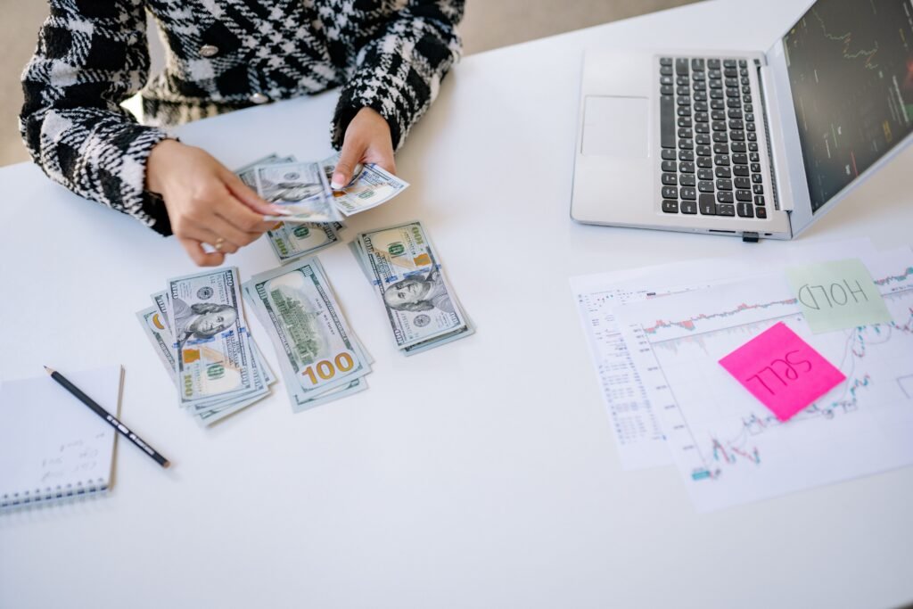 Couple counting cash and reviewing finances together while deciding how to invest $1,000